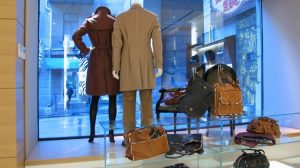 An apparel store where in some clothing and some baggage on display